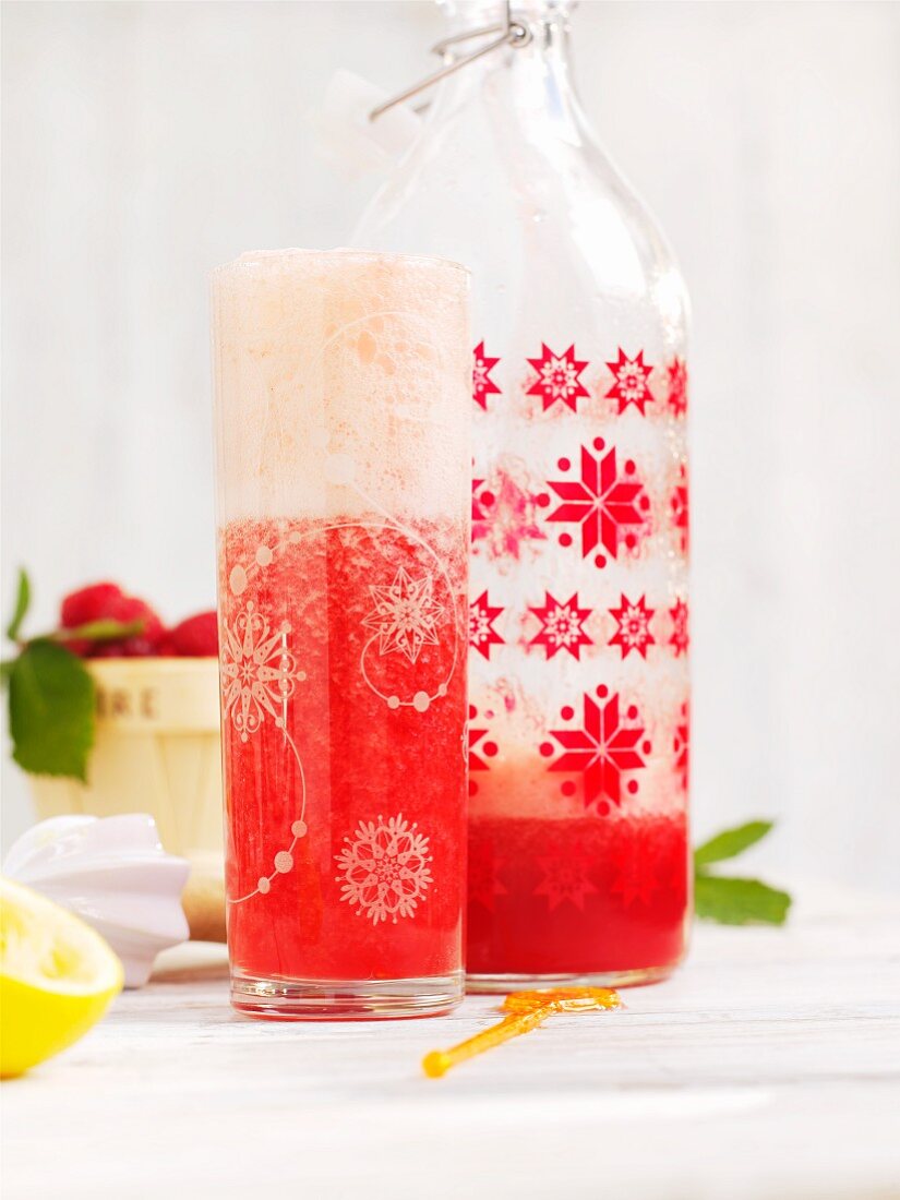 Homemade strawberry lemonade in a bottle and in a glass