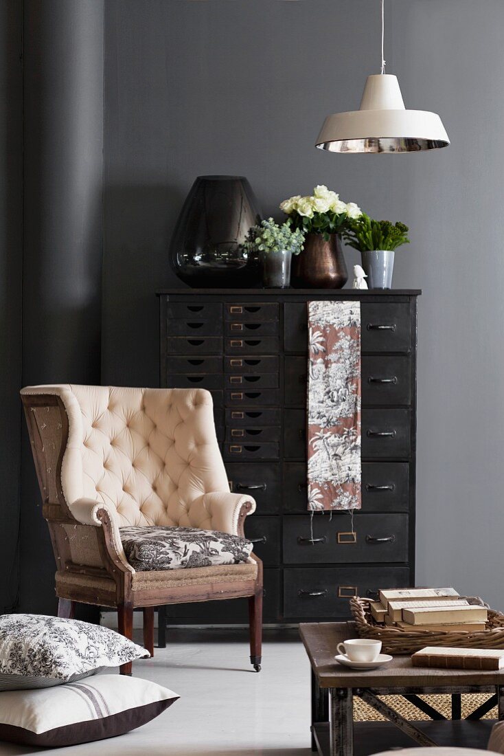 Modern vintage French effect with Toile de jouy; antique armchair in front of black-painted chest of drawers
