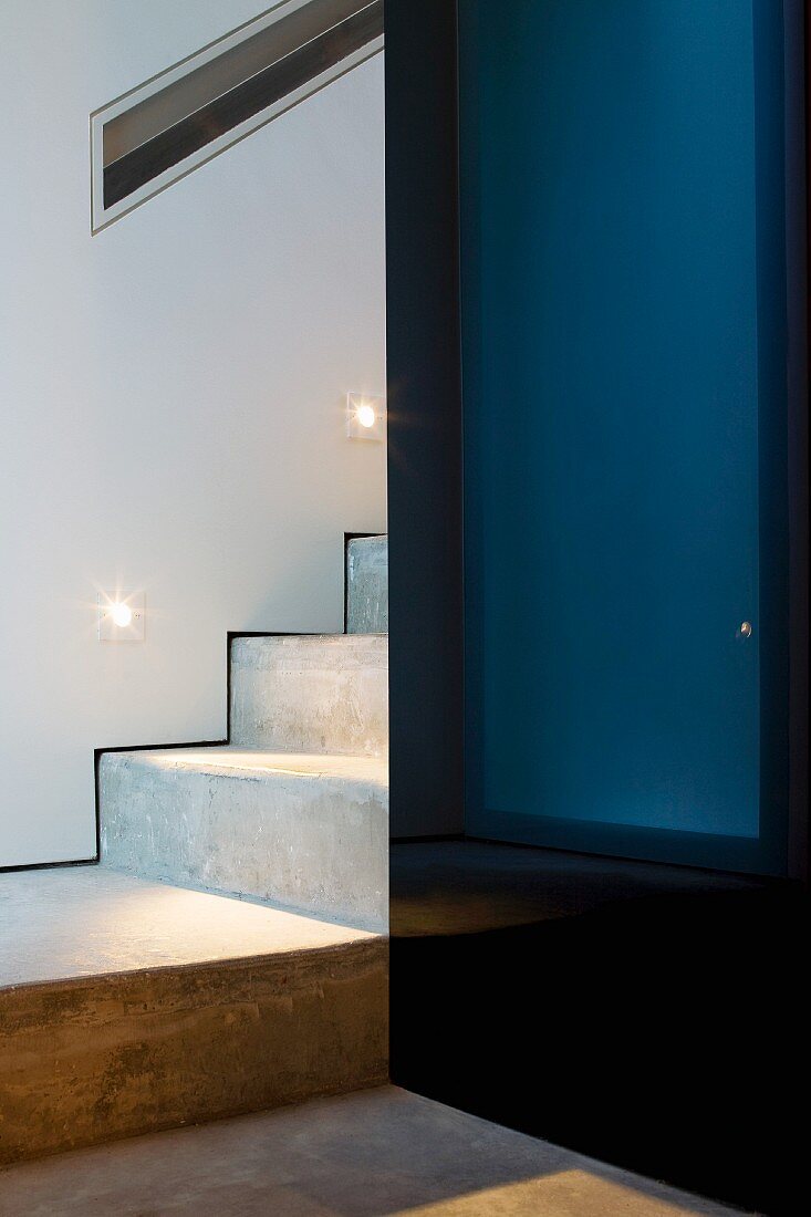 Detail of a staircase with a landing and black lacquered closet