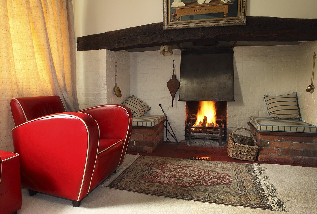 A red leather armchair in front of a fire