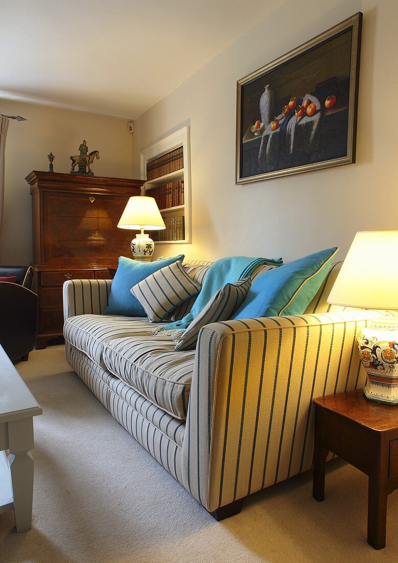 A sofa with a striped cover in a living room