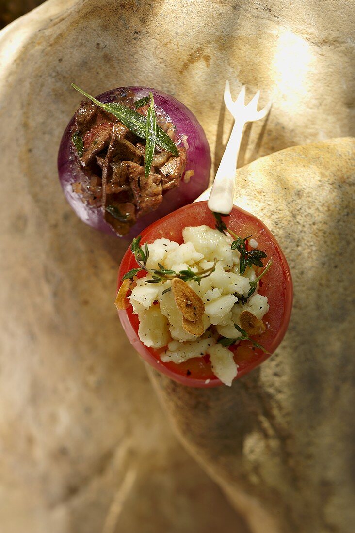 A tomato stuffed with goats cream cheese and an onion stuffed with veal liver