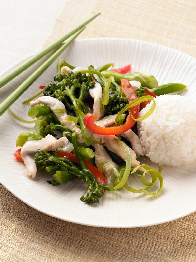 Chicken and Broccolini Stir Fry with White Rice and Chopsticks