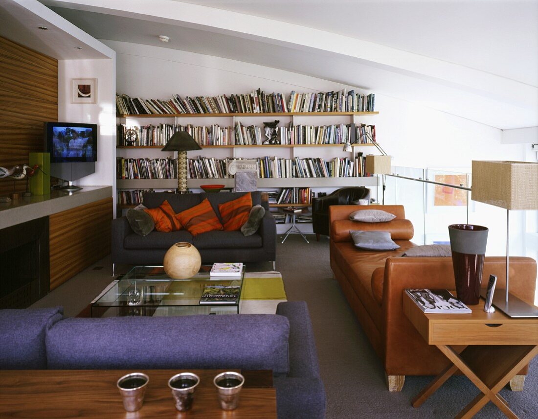 Modern living room with a brown leather recliner and sofas of assorted colors