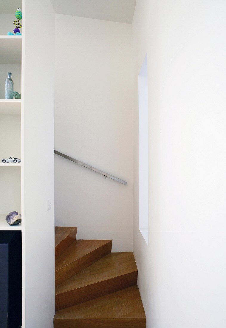 Curved wooden stairway in a narrow stairwell