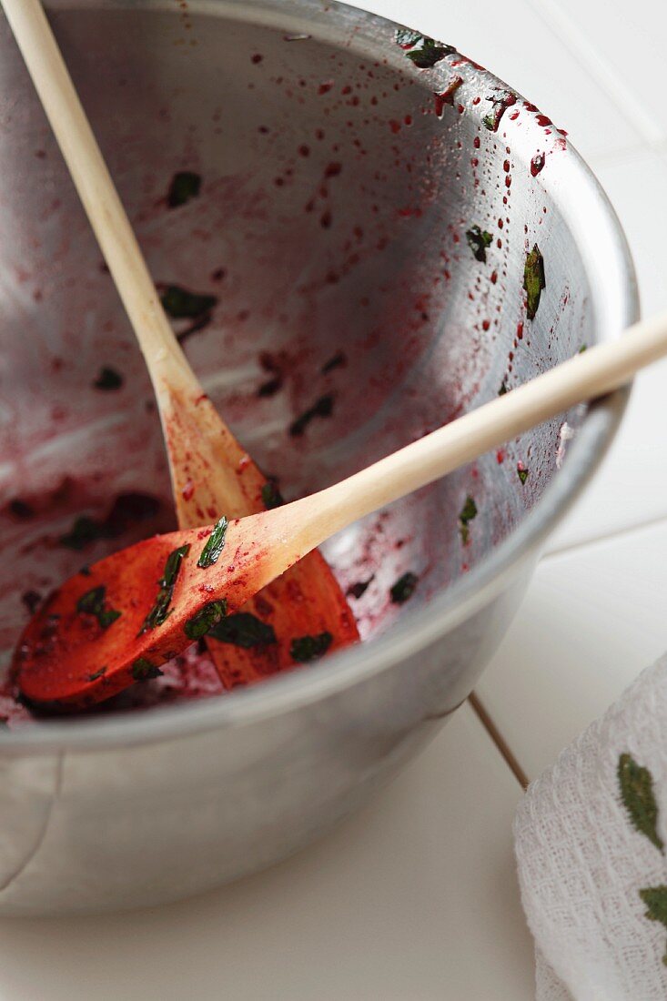 Metal Bowl and Wooden Spoons with Beet Salad Remains