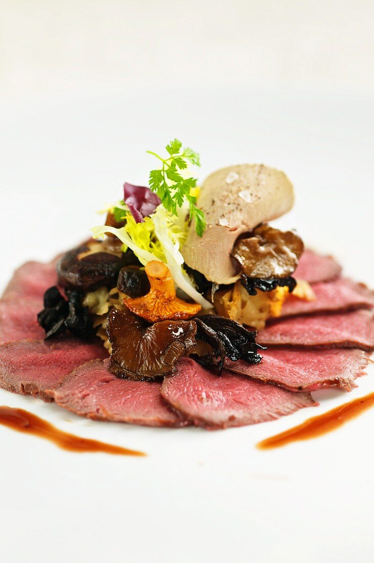 Slices of smoked venison with a mushroom salad