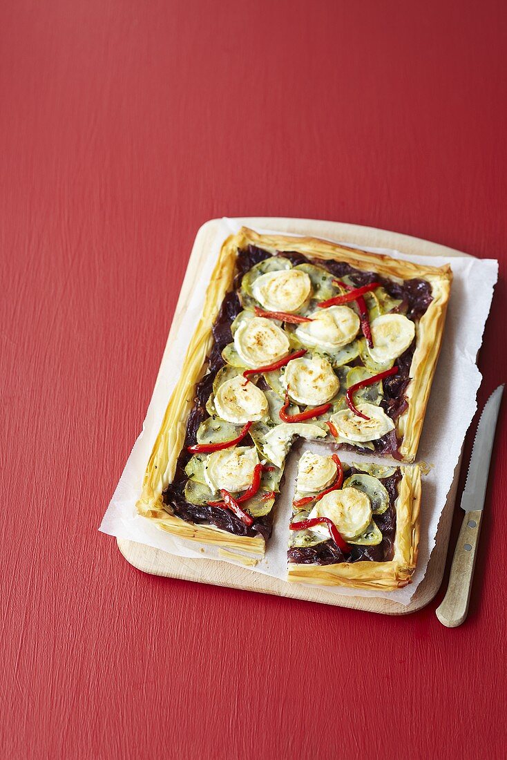 A puff pastry tart with red onions and goat's cheese