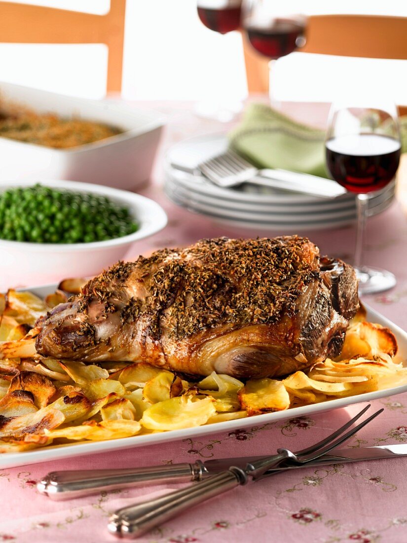 Roast lamb with roast potatoes and peas