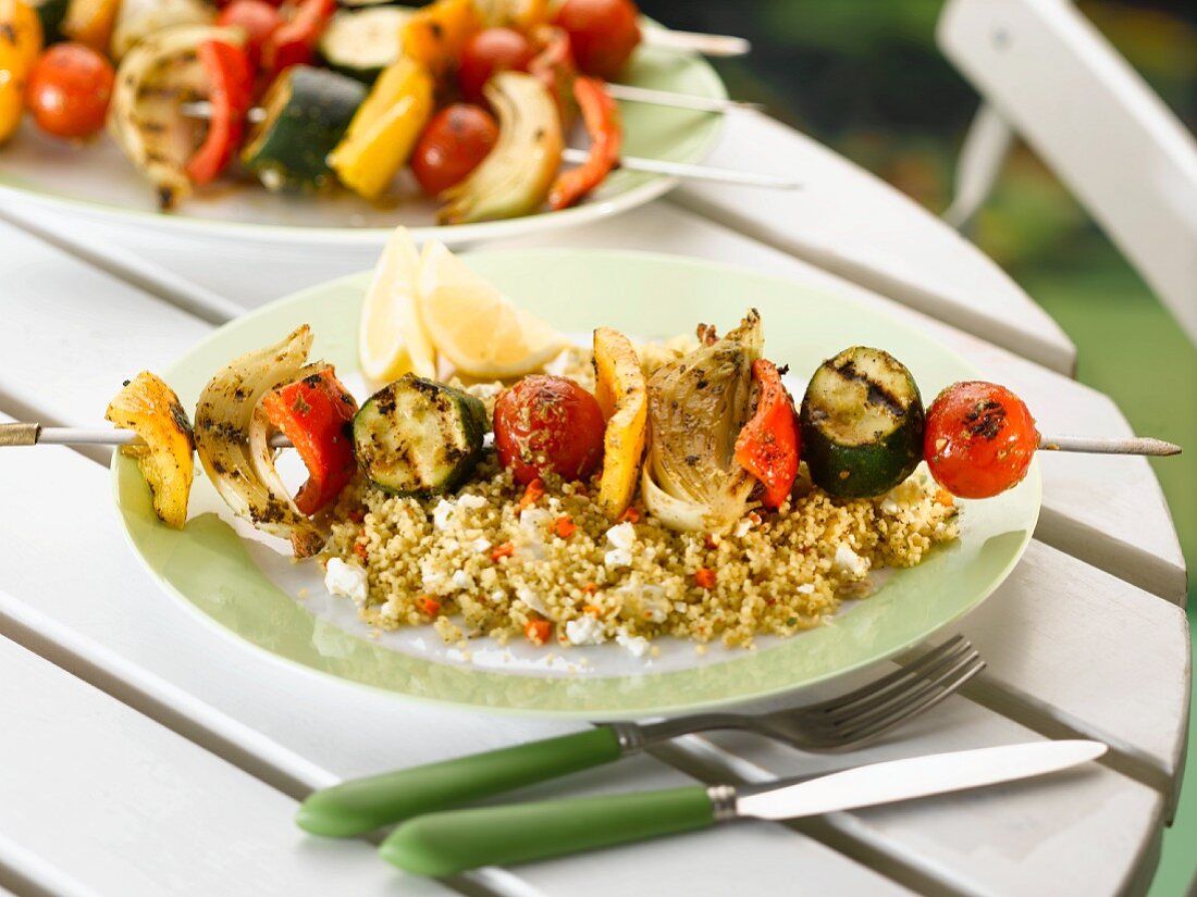 A vegetable kebab on a bed of couscous