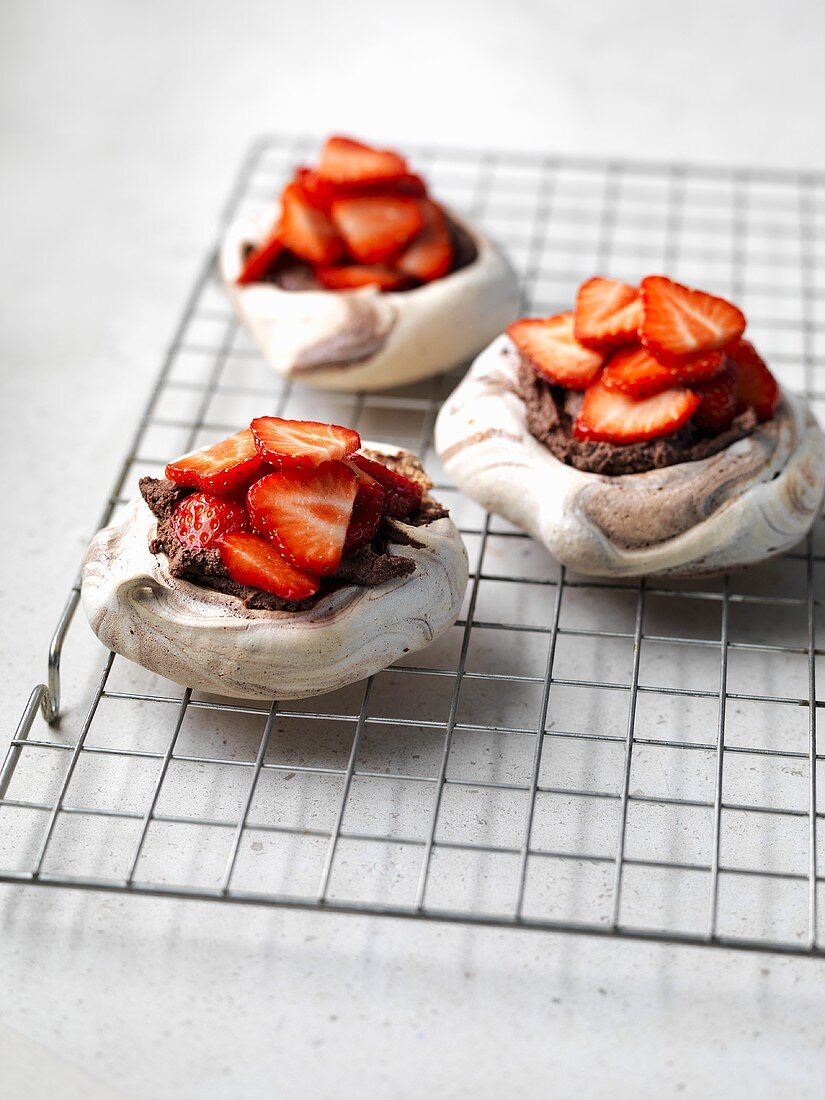 Three chocolate meringue tarts with strawberries