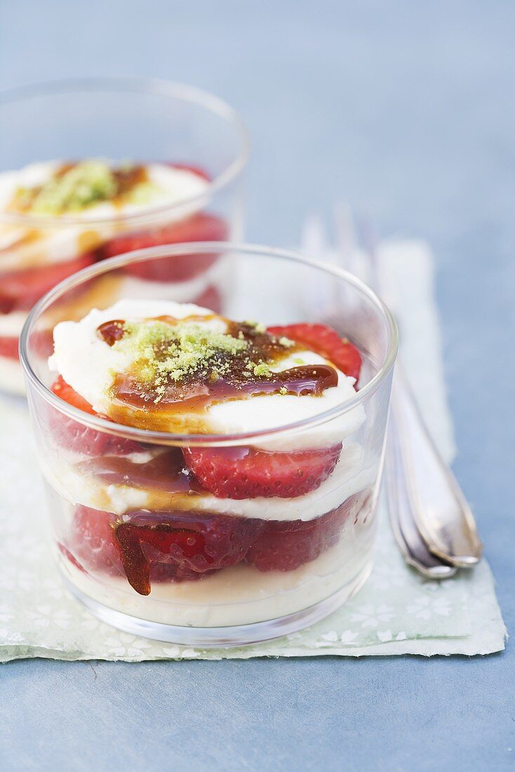 Layered deserts with strawberries, mozzarella and pistachio sugar