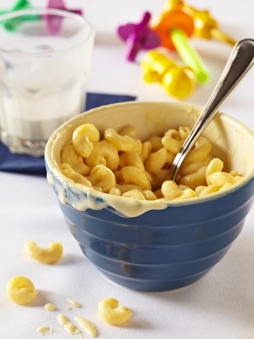 Bowl of Macaroni and Cheese for a Child; Partially Eaten Glass of Milk