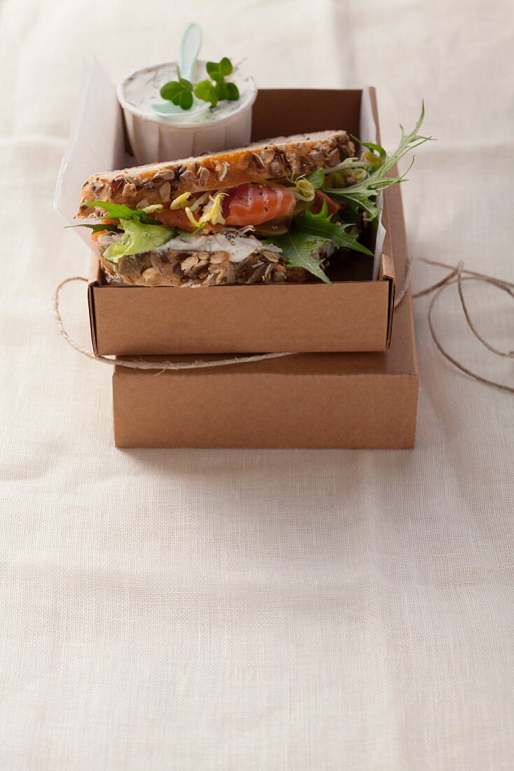 An organic smoked salmon and bean sprouts cream sandwich on wholemeal bread