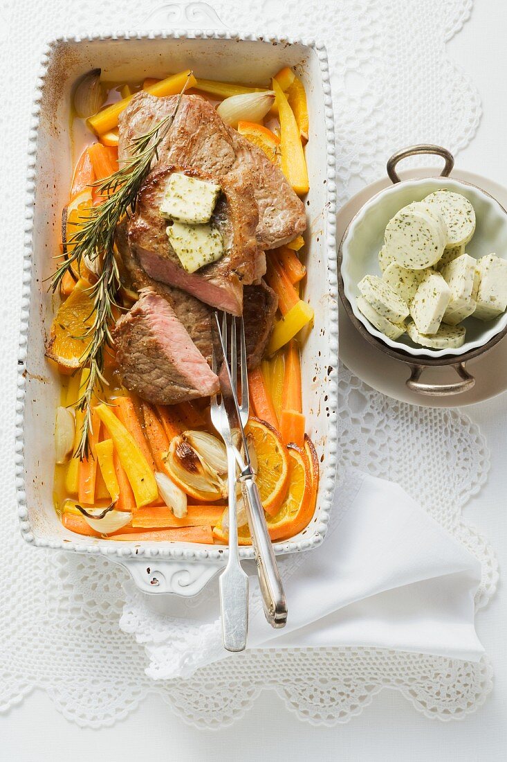 Rump steak with herb butter on a bed of braised carrots