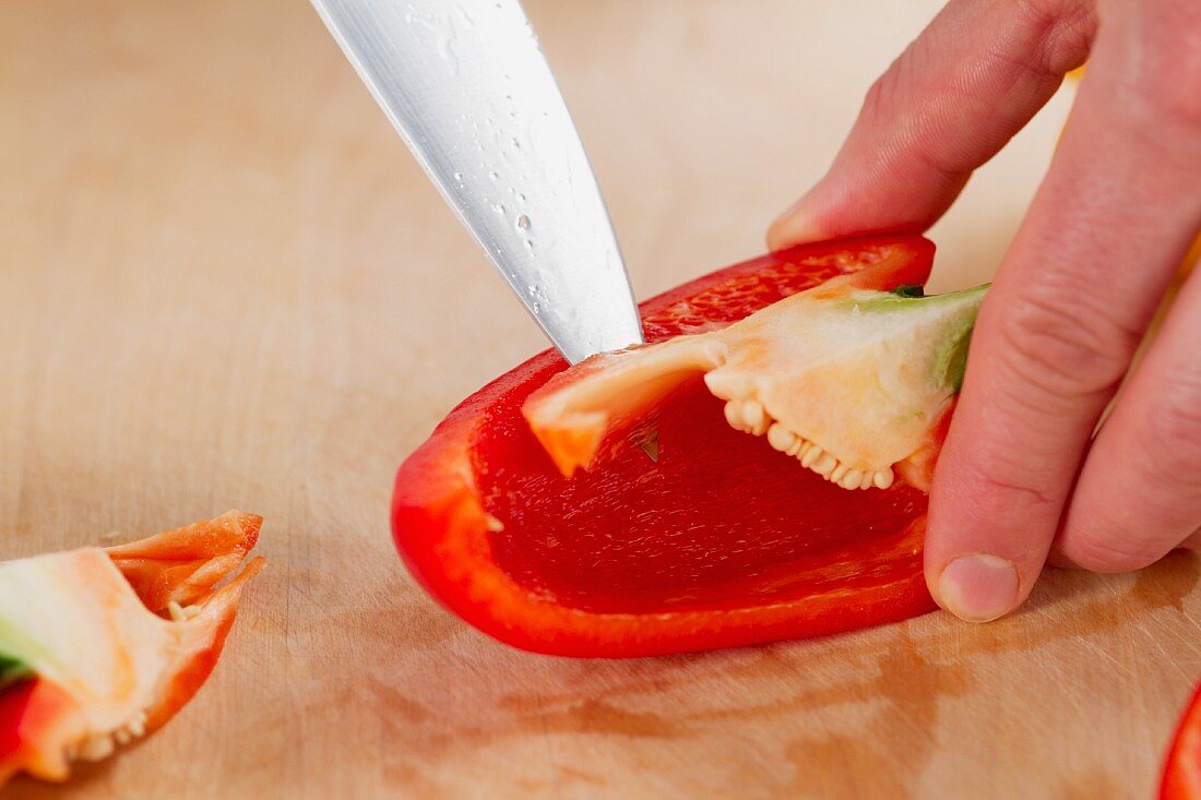 A pepper being deseeded