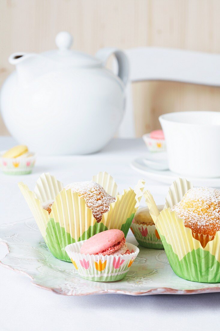 Muffins in tulip-shaped paper cases with macaroons