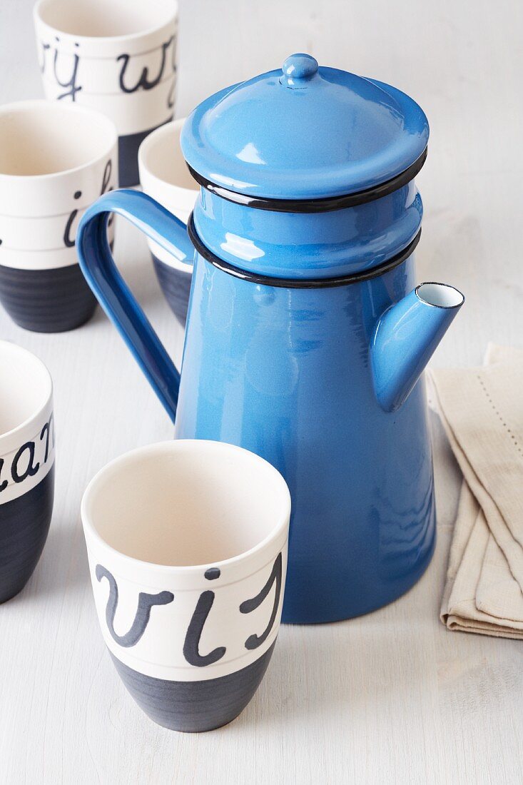 Blue enamel teapot and cup with Dutch writing