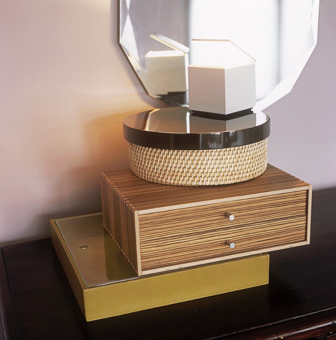 Decorative boxes in front of a wall mirror