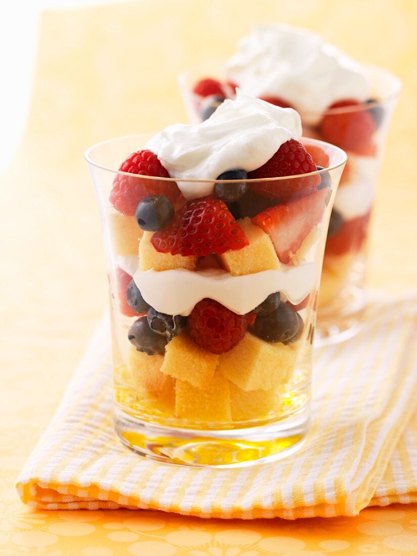 Layered desserts with parfait, berries and cream