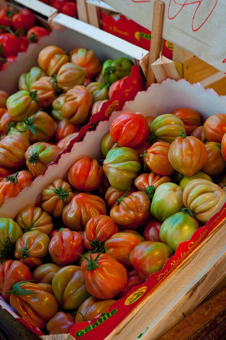 Beefsteak tomatoes in a wooden crate