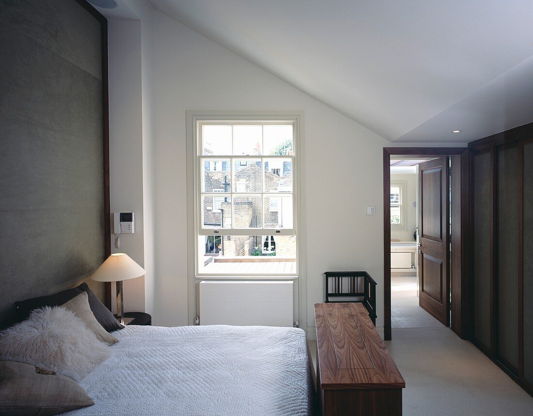 Modern bedroom with ensuite bath, English lattice sash window and storage bench