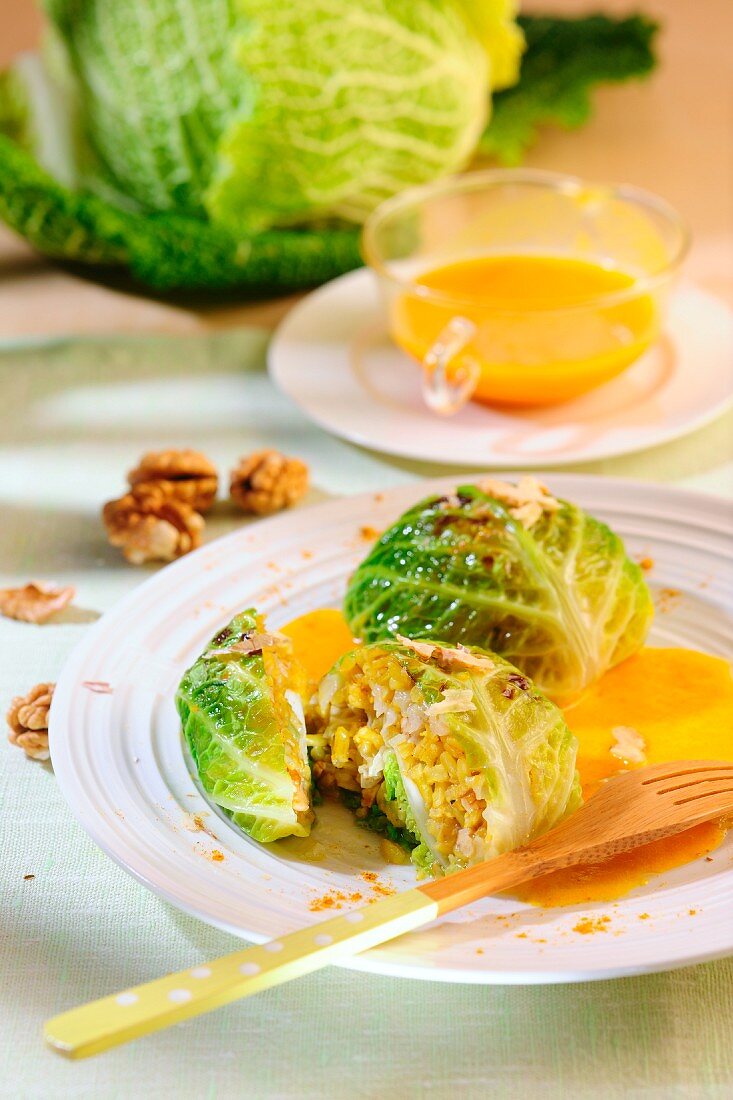 Savoy cabbage parcels filled with walnuts and rice with pumpkin sauce
