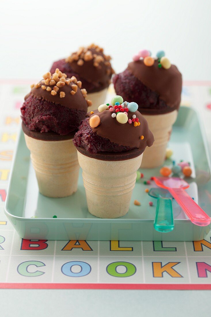 Berry ice cream with chocolate glaze in ice cream cones