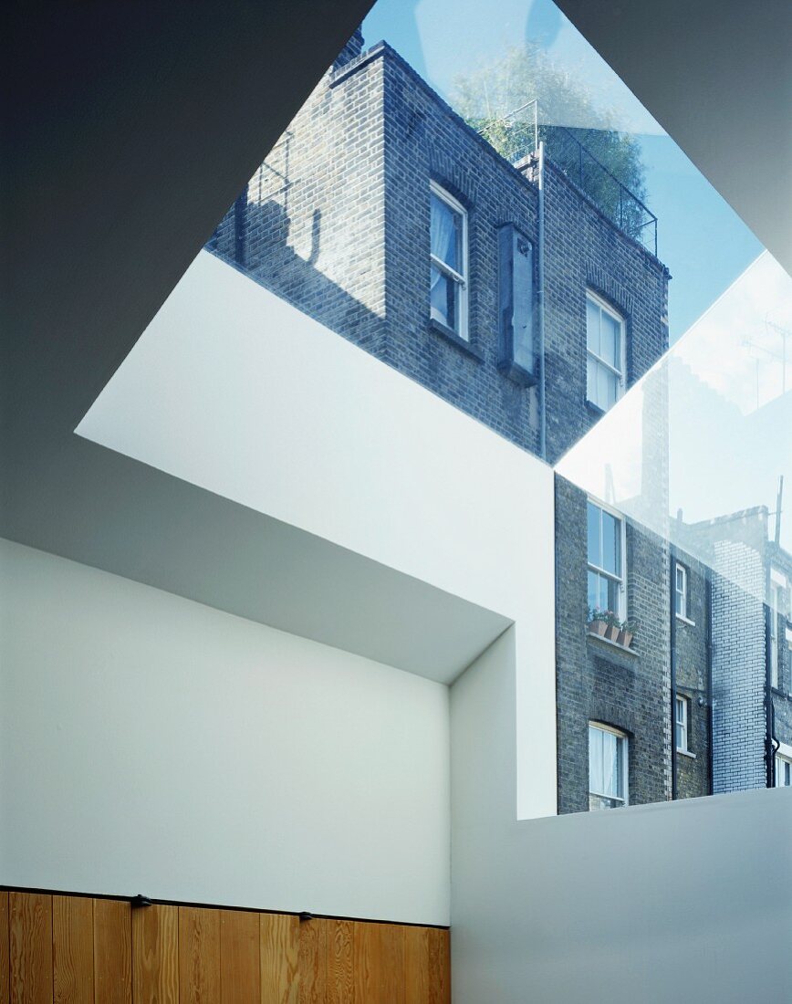 Modern roof with glass section showing view of neighbouring building