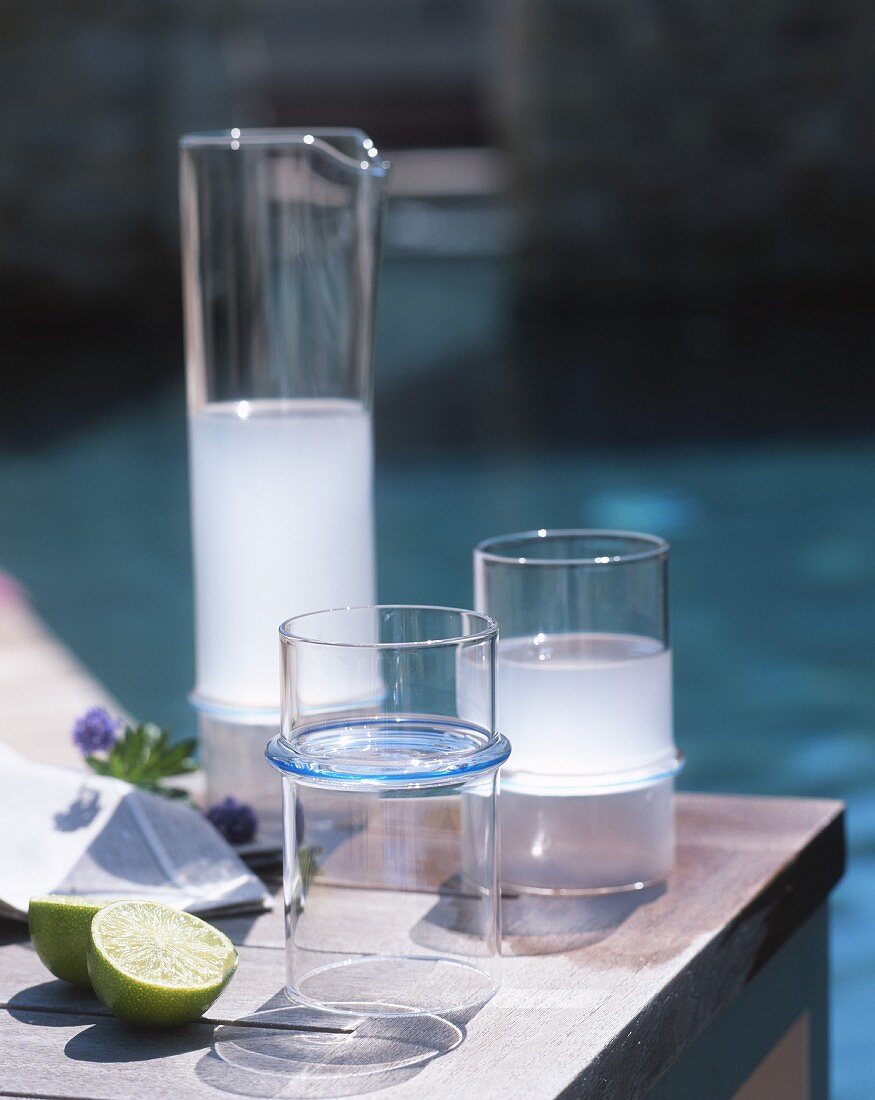 An aperitif in a jug and glasses on table in the open air