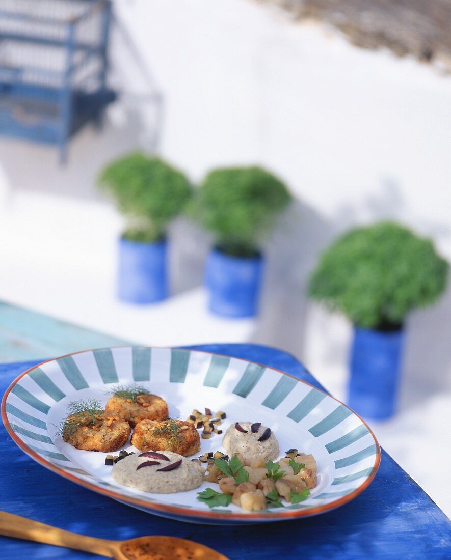A selection of Greek appetisers on a table in the open air