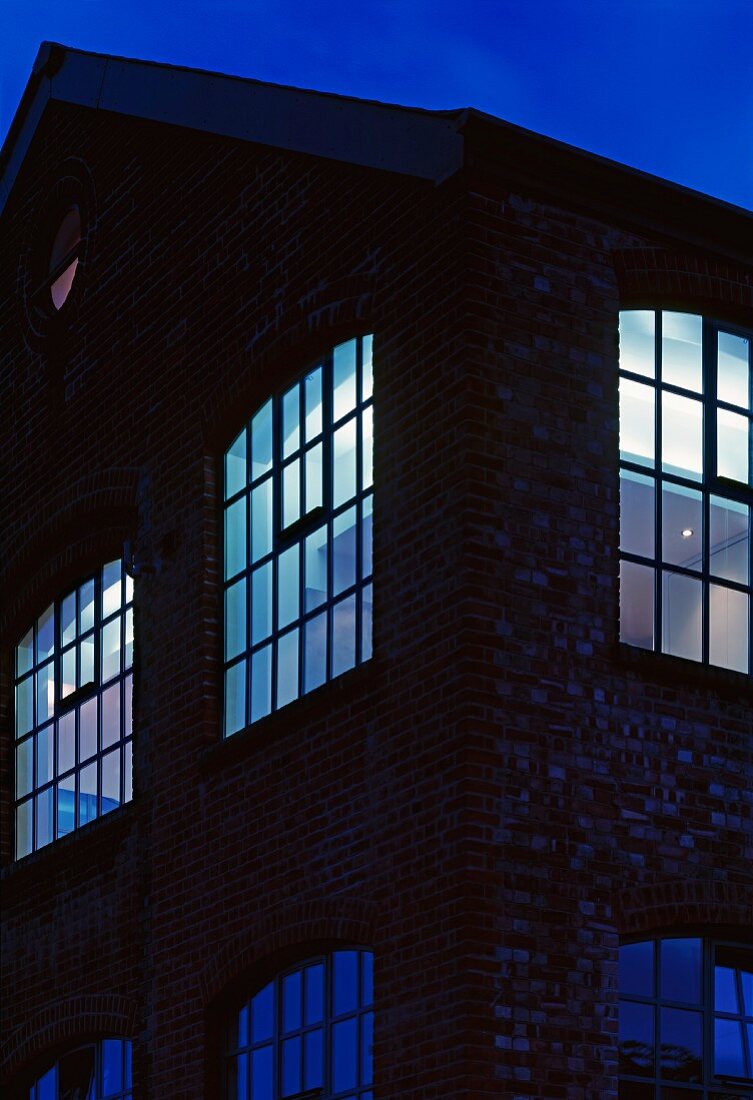 Old factory illuminated in the evening