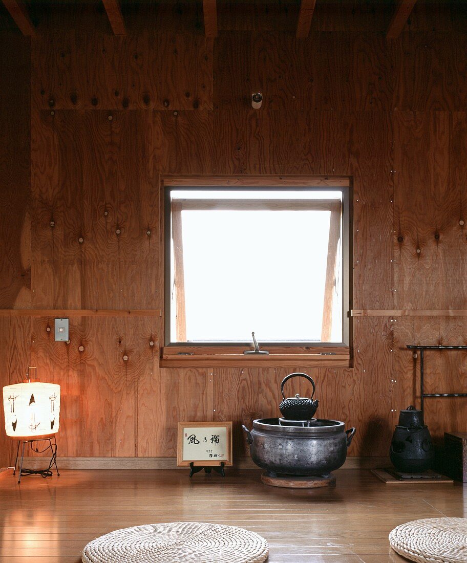 Simple Japanese tea room with wood-clad wall