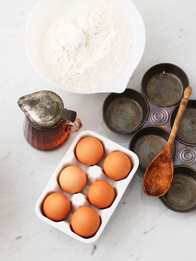 Flour, eggs, maple syrup and a baking tin