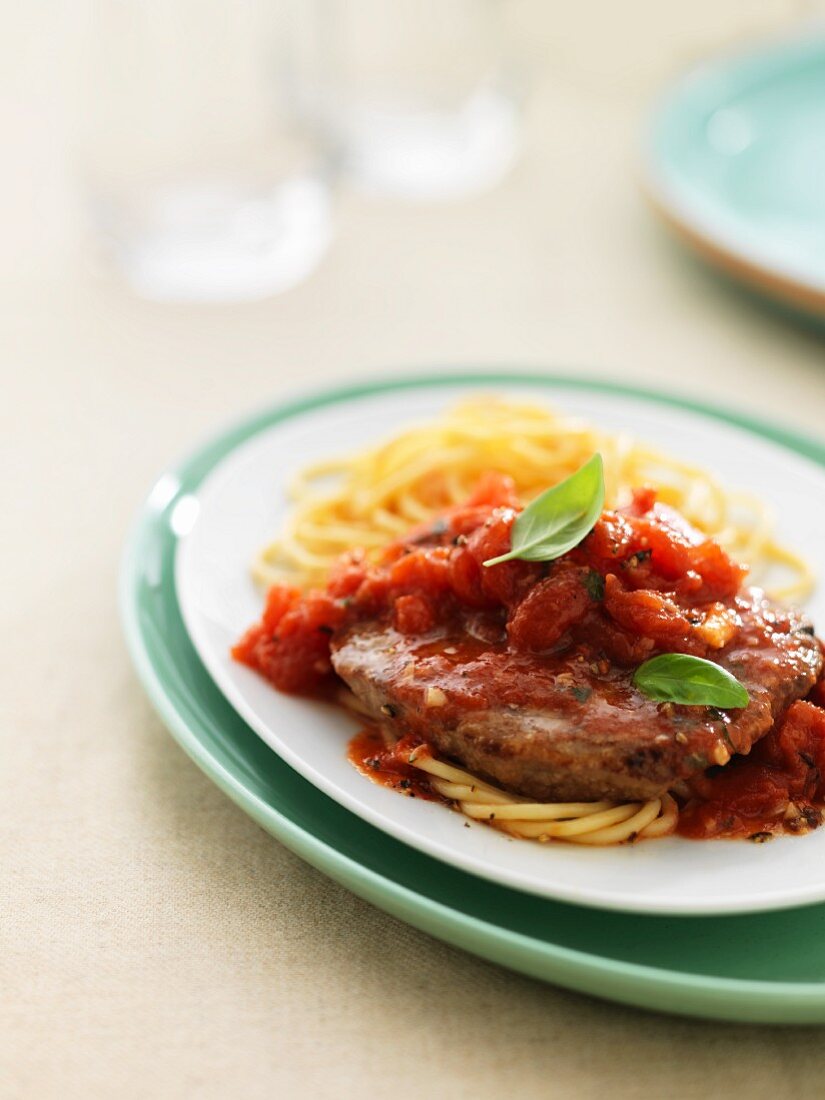 Beefsteak alla pizzaiola with tomatoes and spaghetti