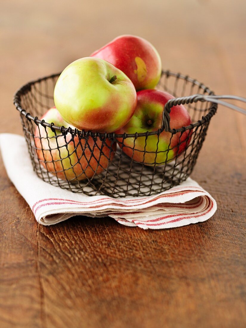 Fresh apples in a wire basket