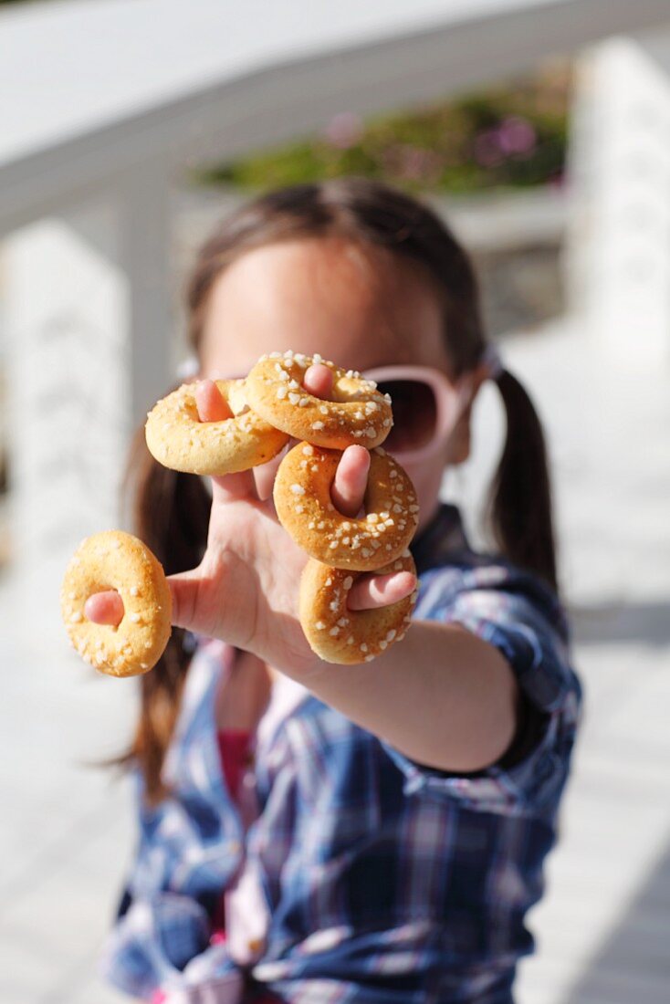 A little girl with mini sweet bread rings