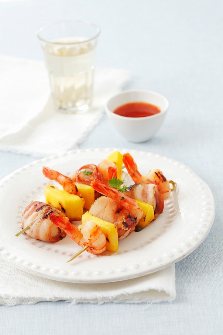 Prawn kebabs with mango and scallops wrapped in bacon