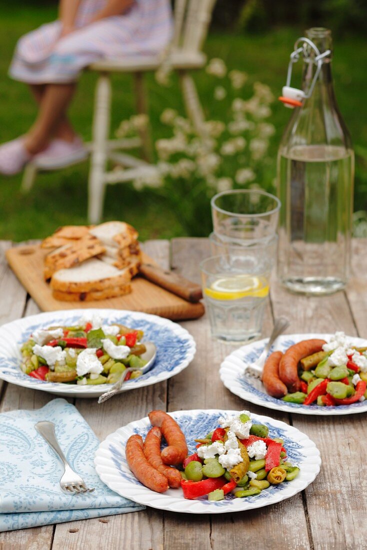Frankfurters with a bean and pepper salad and goats cheese