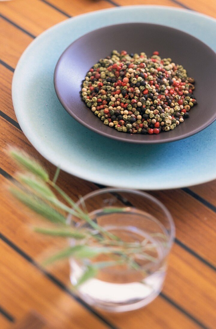 A bowl of colourful peppercorns