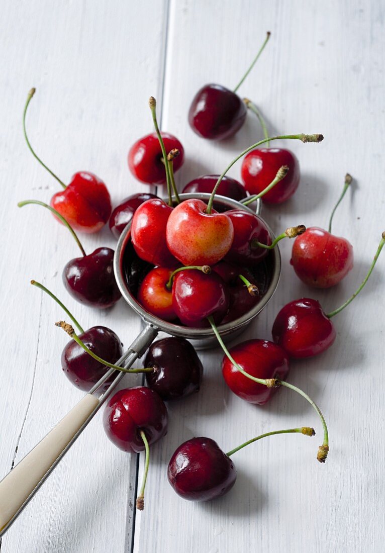 Sweet cherries some in a tea strainer