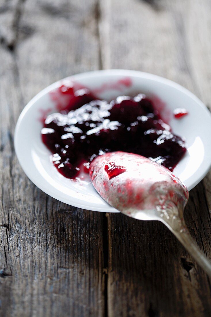 Sweet cherry jam on a plate with a spoon