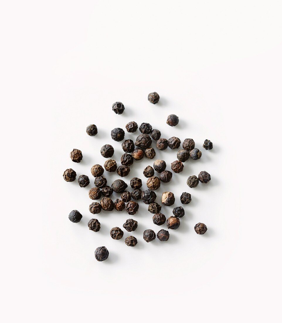 Black pepper in scoop, close-up