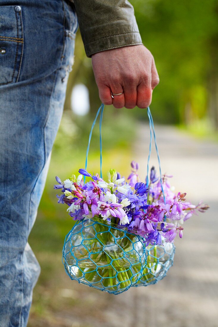 A person holding a jar of Spanish bluebells