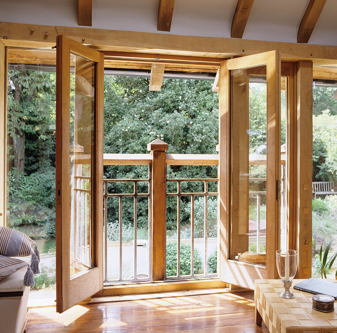 Open doors to balcony with garden view