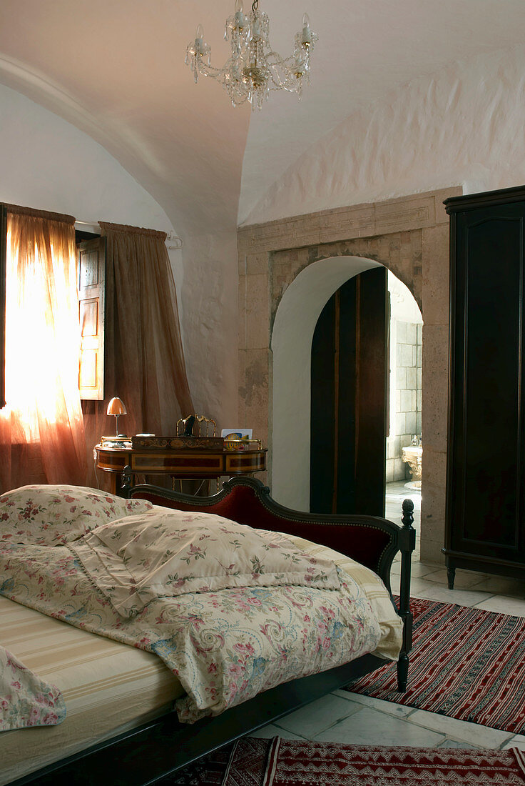 Double bed in bedroom with vaulted ceiling