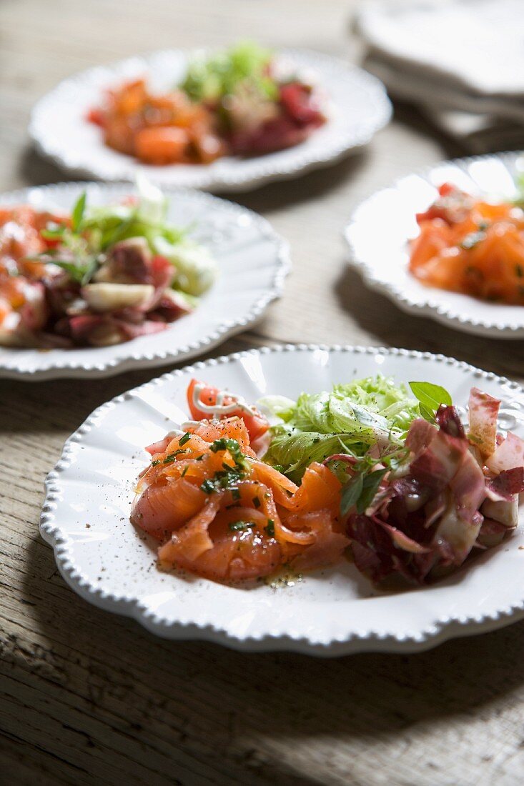 Plated starters of smoked salmon and salad