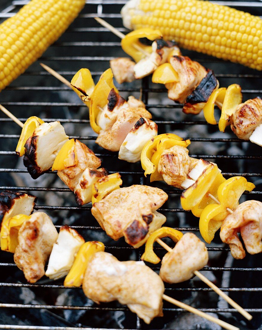 Kebabs and corn cobs on a barbecue