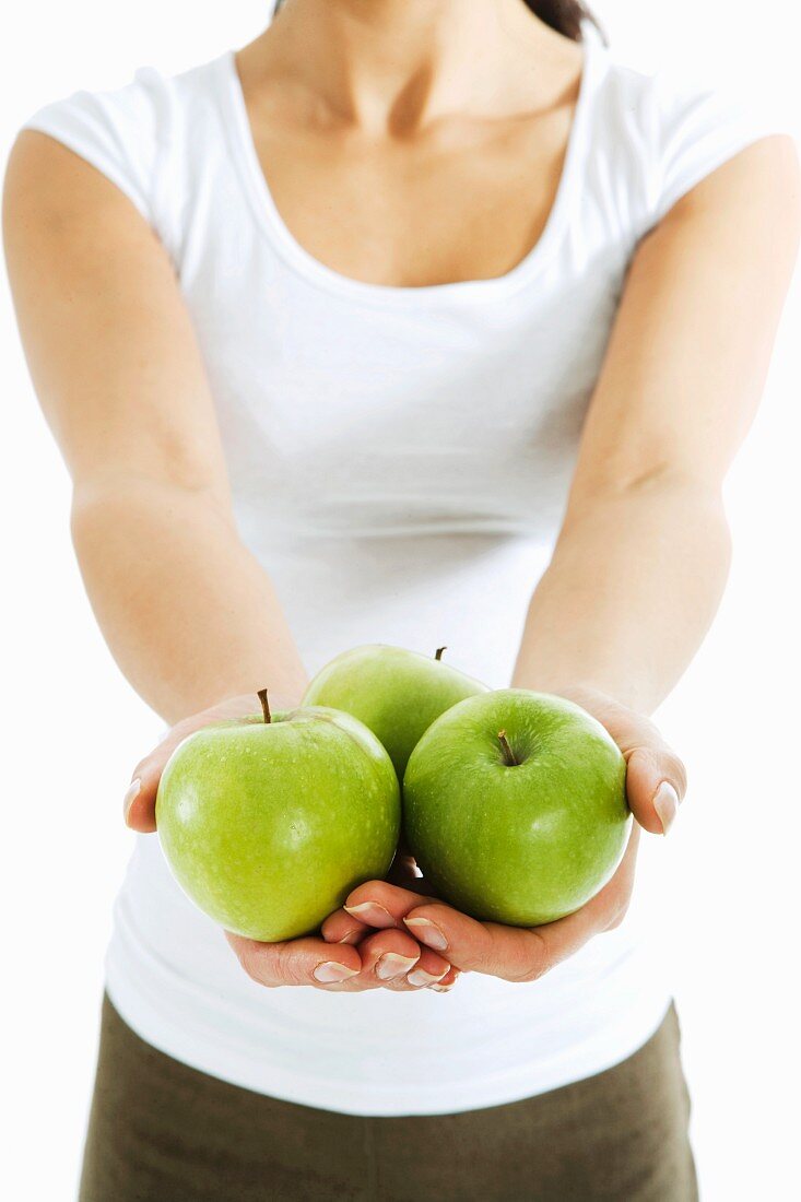 A woman holding apples