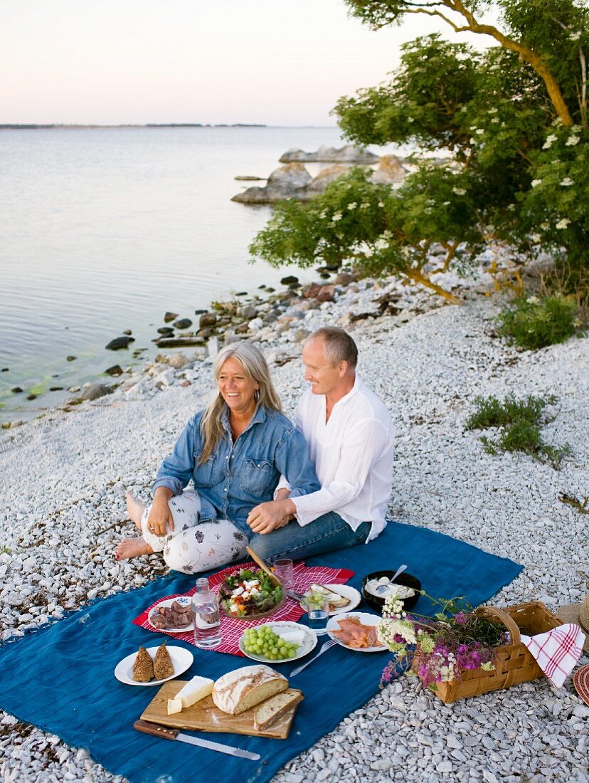 A couple having a picnic on the beach